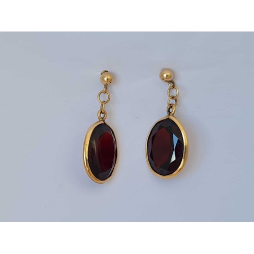 85 - A pair of dangle drop earrings set with garnets 9ct   3.8 gms