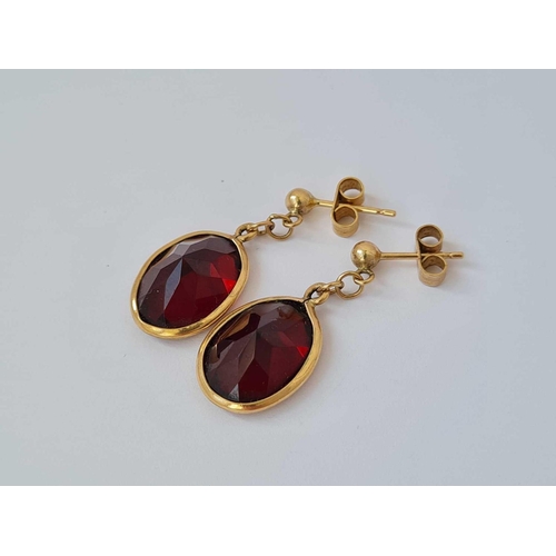 85 - A pair of dangle drop earrings set with garnets 9ct   3.8 gms