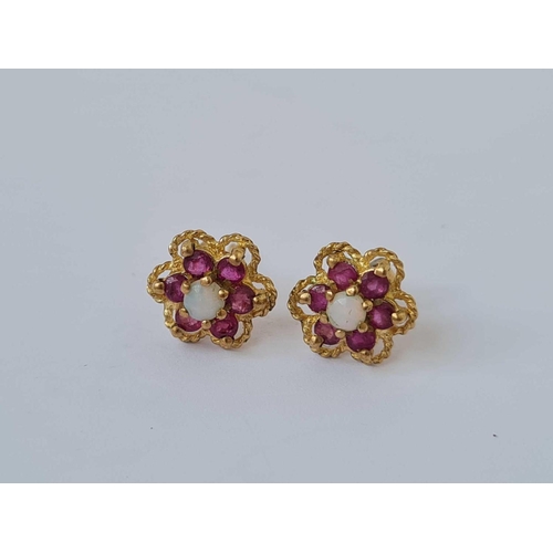 89 - A pair of opal and ruby daisy head earrings 9ct