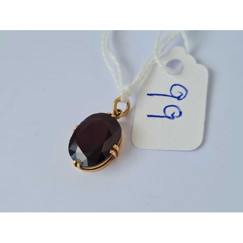 99 - A gold and garnet drop pendant