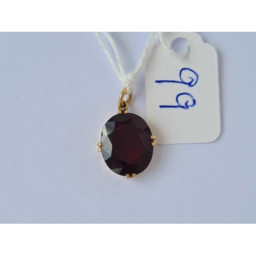 99 - A gold and garnet drop pendant