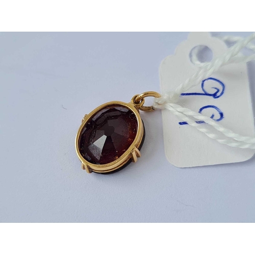 99 - A gold and garnet drop pendant