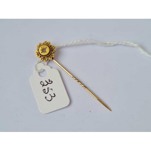 353 - A stick pin with diamond top 15ct gold