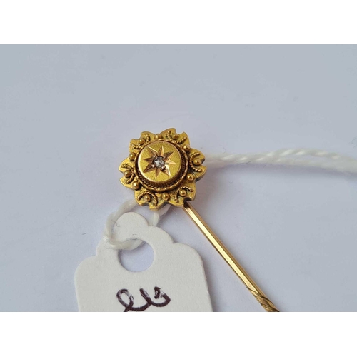 353 - A stick pin with diamond top 15ct gold