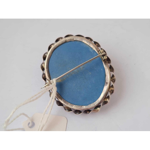 493 - A blue stone cameo set silver brooch