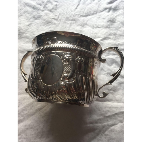 924 - A large two handled cup of Queen Anne design, half fluted with vacant cartouche, 10