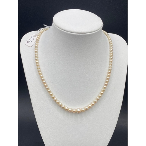 274 - A NATURAL SINGLE STRAND PEARL NECKLACE WITH RUBY & DIAMOND CLASP