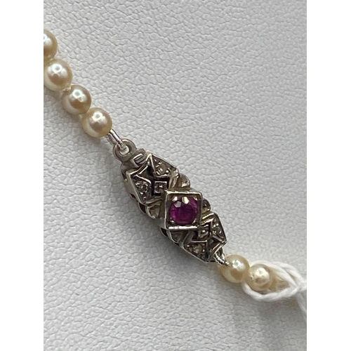 274 - A NATURAL SINGLE STRAND PEARL NECKLACE WITH RUBY & DIAMOND CLASP