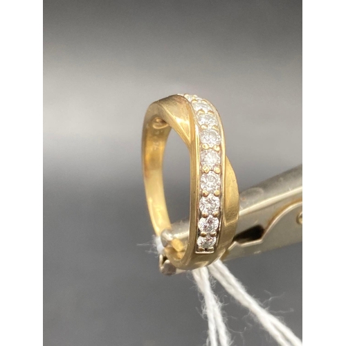 275 - A fine diamond twist ring in 9ct � carat diamond size M