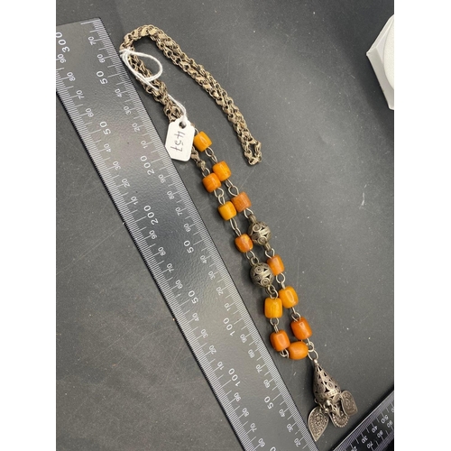 457 - A early 20th century ethnic silver and butterscotch amber necklace