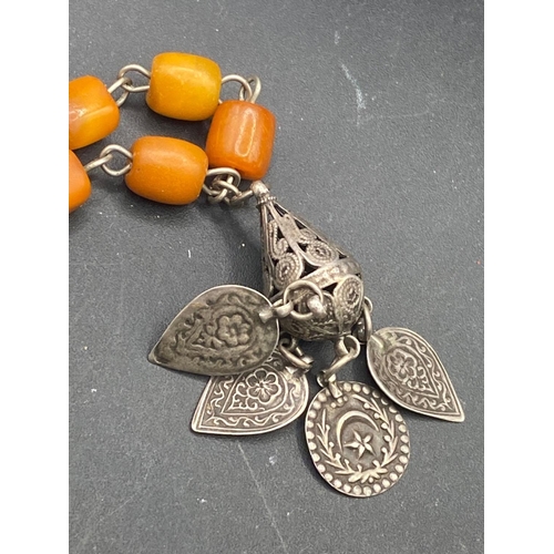 457 - A early 20th century ethnic silver and butterscotch amber necklace