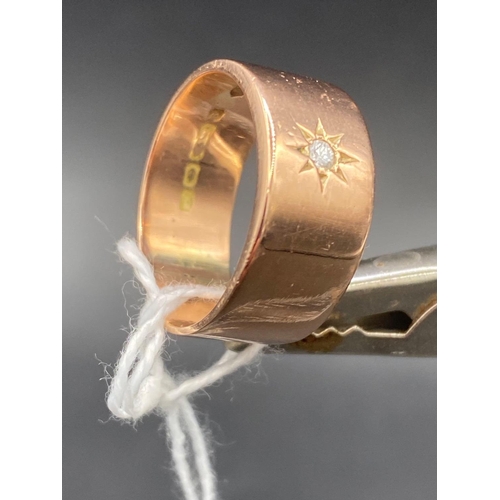 77 - A wide 9ct rose gold band ring set with a single diamond size R 6.4g