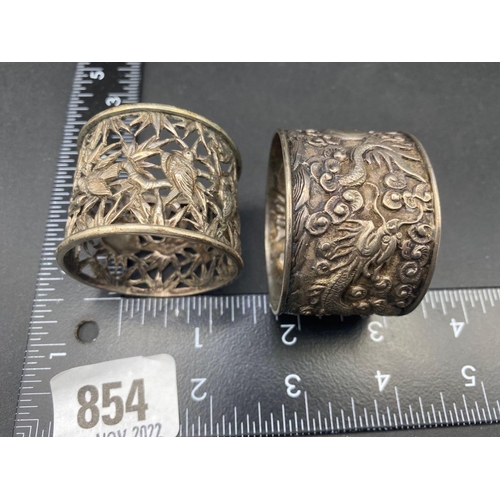 854 - A Chinese napkin ring decorated with Dragons and another with Birds, 44g