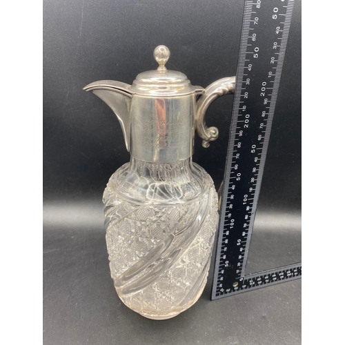 914 - A good cut glass silver mounted claret jug with hinged cover, scroll handle, 9.5