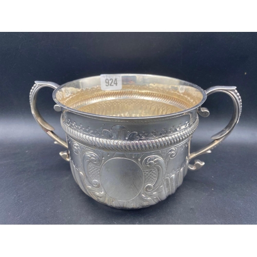 924 - A large two handled cup of Queen Anne design, half fluted with vacant cartouche, 10