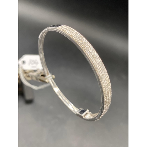 104 - A DIAMOND SET HINGED 9ct white gold bangle 13.5g inc