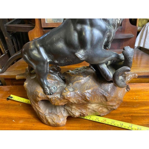 1665 - Good Oriental bronze of a Lion attacking a Leopard, bead eyes. 15 inch high including Wood base