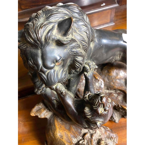 1665 - Good Oriental bronze of a Lion attacking a Leopard, bead eyes. 15 inch high including Wood base