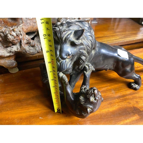 1665 - Good Oriental bronze of a Lion attacking a Leopard, bead eyes. 15 inch high including Wood base