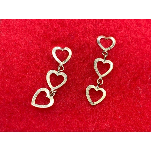 276 - A pair of drop earrings in the form of three hearts 9ct