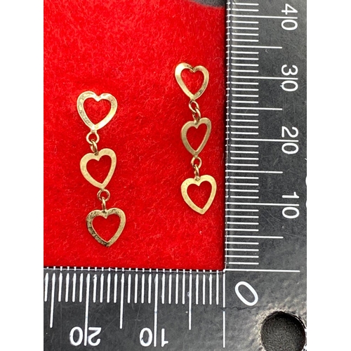 276 - A pair of drop earrings in the form of three hearts 9ct