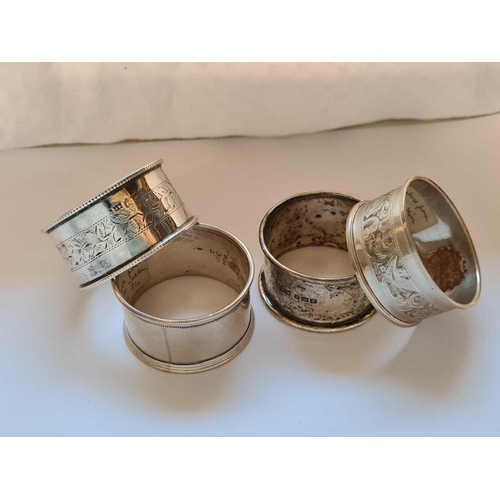 736 - A napkin ring with beaded edges, another Birmingham 1910 and two others, 58g