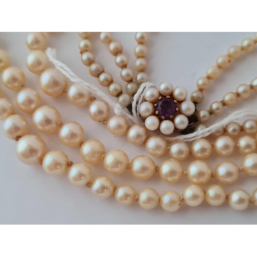 115 - A triple string of pearls with 9ct clasp