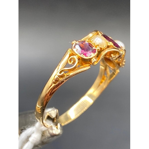 134 - A pretty earl Victorian almandine garnet and pearl ring with scrolled shoulders Size O