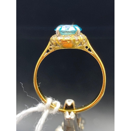 135 - A pretty blue zircon and diamond ring in high carat gold Size N 2.3g