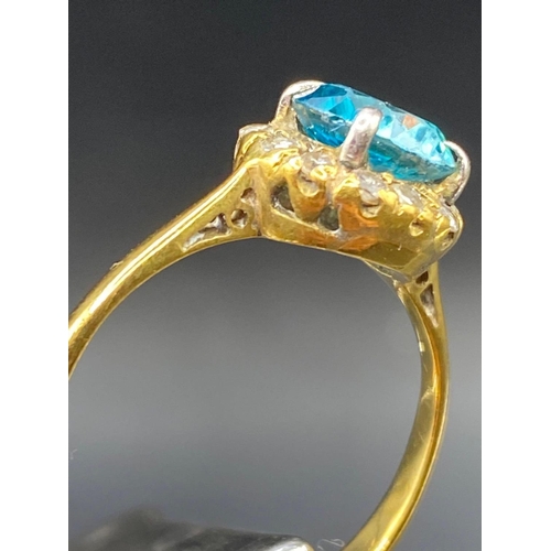 135 - A pretty blue zircon and diamond ring in high carat gold Size N 2.3g