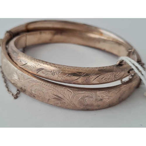 209 - A engraved silver hinged bangle together with a small example