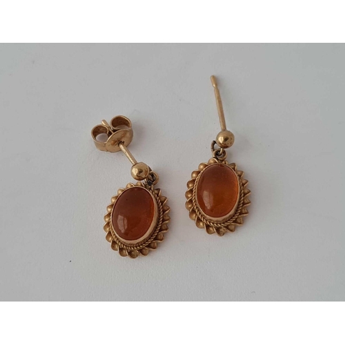 30 - A pair of amber earrings 9ct