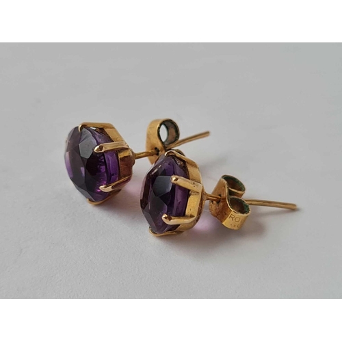 329 - A pair of amethyst ear studs 9ct