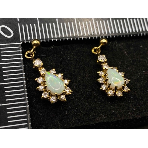 445 - A pair of pretty opal and diamond earrings