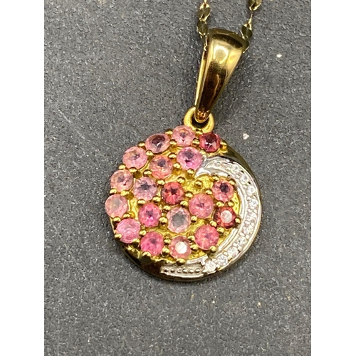 446 - A diamond and pink tourmaline swirl pendant 10ct gold with fancy necklace 16