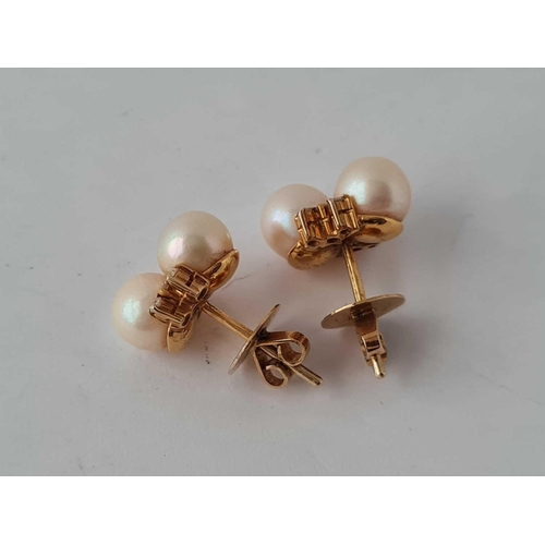 454 - A pair of pearl and diamond earrings 18ct gold     6.1 gms