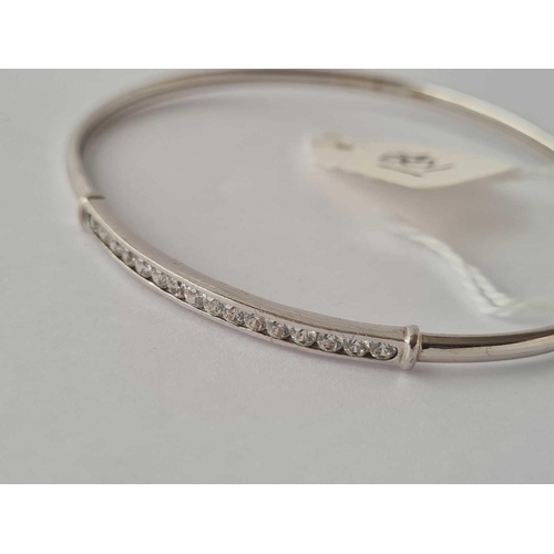 501 - A white stone 9ct gold hinged bangle 4.2g