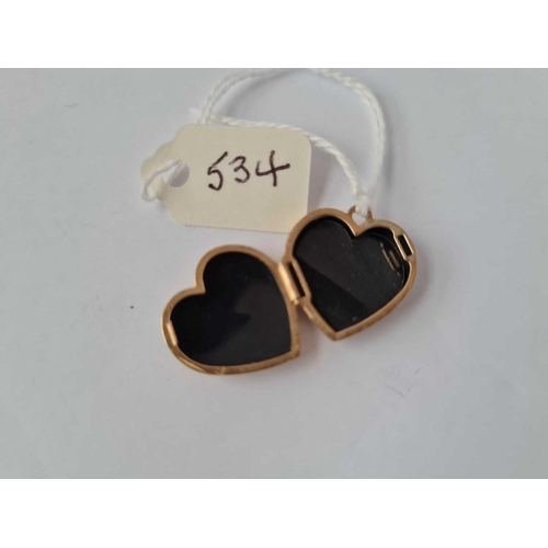 534 - A heart shaped locket set with a diamond 9ct