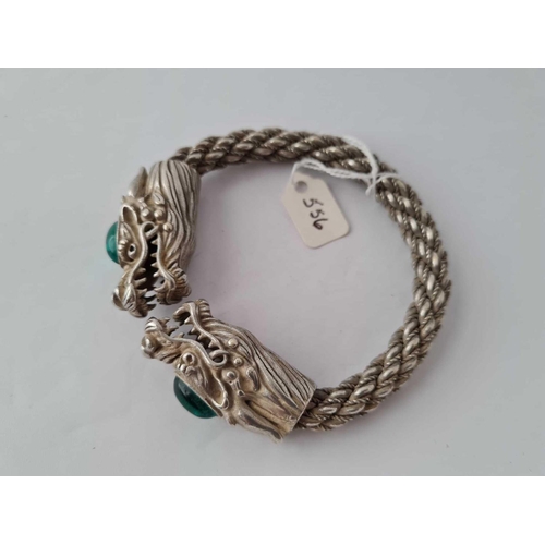 556 - A impressive silver rope twist bangle with two stone set dragons head