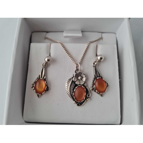 561 - Two heavy silver bangles 46g and an orange stone set silver necklace & earrings set