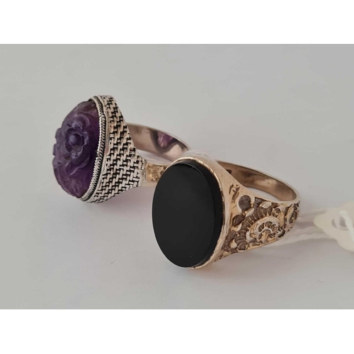 619 - A silver Chinese carved amethyst ring and a plain example