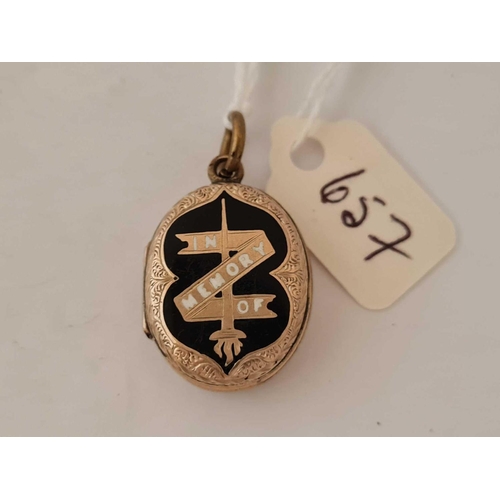 657 - A gold  back and front enamel mourning locket