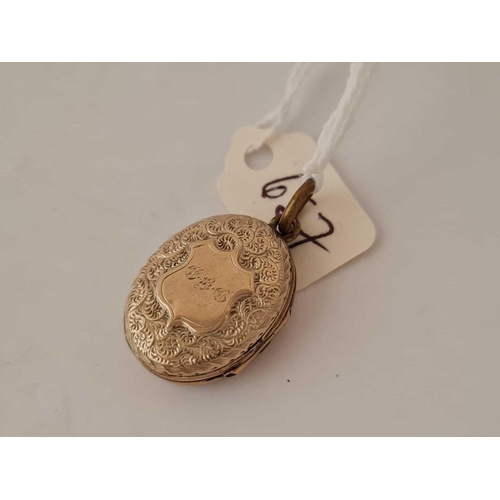 657 - A gold  back and front enamel mourning locket