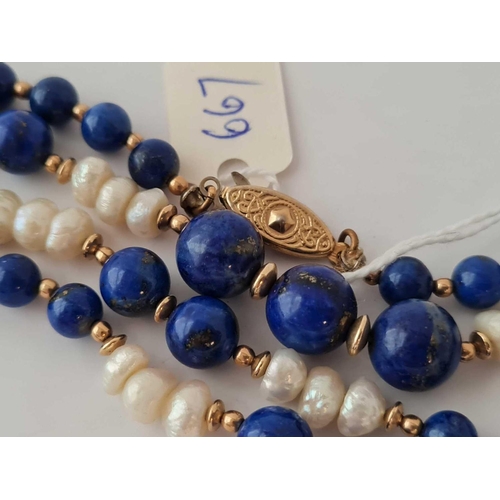 667 - A lapis and baroque pearl necklace