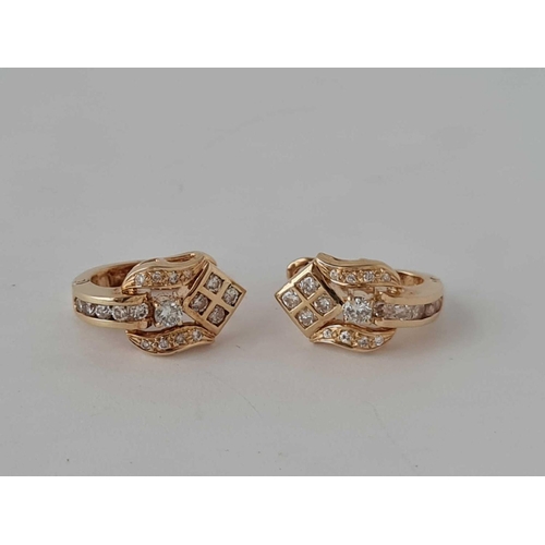 67 - An attractive pair of diamond earrings in 14ct gold 4.1g