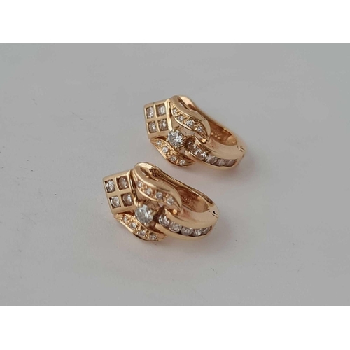 67 - An attractive pair of diamond earrings in 14ct gold 4.1g