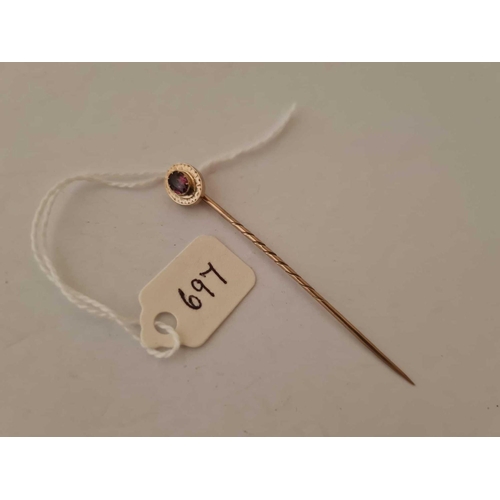 697 - A gold and garnet topped stick pin