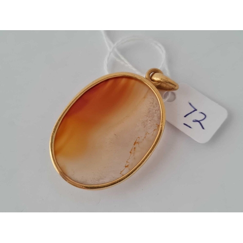 72 - A large orange agate oval pendant 4cm long in heavy 18ct gold frame 18.8g inc