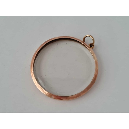 9 - A large circular antique 9ct rose gold photo locket