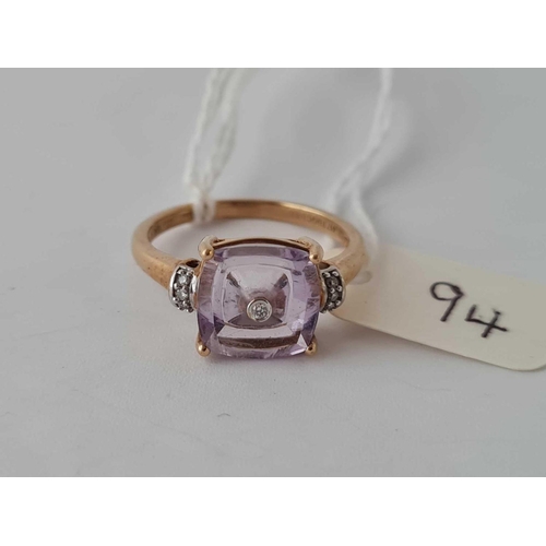 94 - A amethyst ring with diamond centre and shoulders 9ct